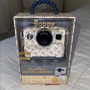 White Digital Camera with Blue ribbon Accents